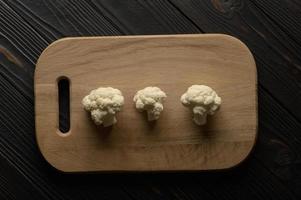 Raw, fresh organic cauliflower on a wooden background. Healthy eating, low carb diet concept photo