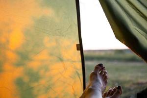 View from inside the tourist tent on a sunny day and nature. Active camping, environmental friendliness, adventure photo