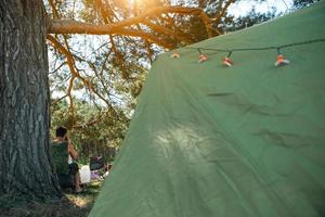 A tourist tent in a camping in nature. Summer outdoor activities, adventures. Mock up photo