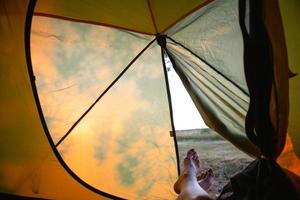 View from inside the tourist tent on a sunny day and nature. Active camping, environmental friendliness, adventure photo