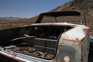 Wrecked and rusty car in Death Valley photo