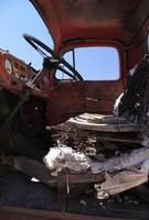 Abandoned car in Death Valley, California, with the steering wheel in the foreground photo