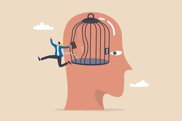 Freedom, break free from prison of thinking, inspiration or think out of the box, psychology or mental therapy, emotional concept, confidence businessman jump out of cage in his head for freedom.