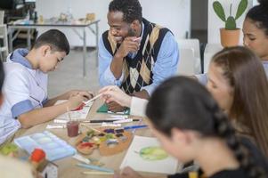 group of students studying and playing with teacher, education and learning concept. photo