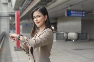 Businesswoman is using Smart watch in Modern city , business technology , city lifestyle concept photo