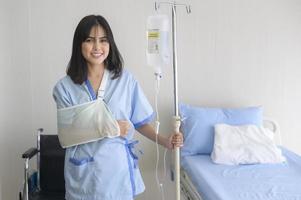 Hopeful and happy young patient woman in hospital, healthcare and medical concept photo