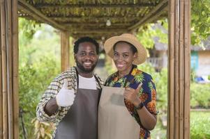 Happy black agronomist couple enjoying and working in farmland, agriculture concept photo