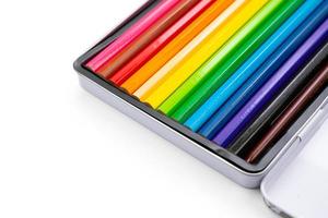 Used 12 colour pencils and apply to water colour painting. There are arranged in steel box on white background in stuido light. Clipping path. photo
