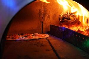 Vintage old Oven with fire inside for baking Original Pizza. photo