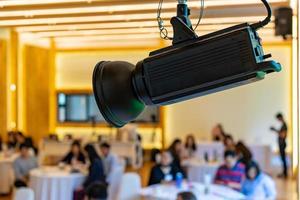 LED spotlight in the seminar classroom hall with blur people behind. photo