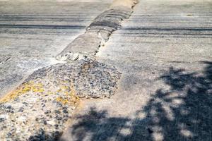 Close up Cracking Speed Bump on the Asphalt Road at noon in Bangkok Thailand. photo