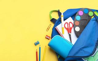 Top view of school backpack and school supplies with space for text. Back to school concept photo