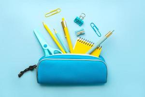 Top view of pencil case with school supplies. Back to school concept photo