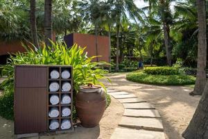 rolling towel in the wooden square box in the private hotel beach garden, prepared for traveler to use. photo