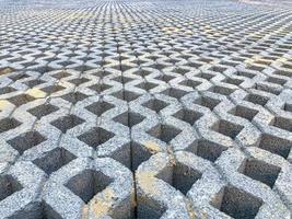 gray color stone brick block floor tile with green grass and sand as background or texture. photo