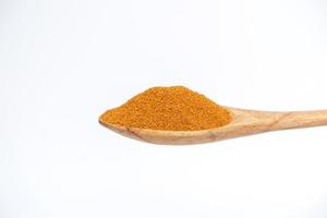 Cayenne in the wooden spoon isolated on a white background. photo