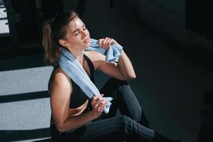 Sweating after workout. Photo of gorgeous blonde woman in the gym at her weekend time