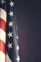 Standing flag United States of America on dark gray background.Banner of America in retro style. photo