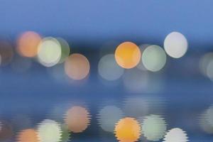 Circle bokeh is reflected in the water and the design concept. photo