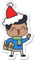 sticker cartoon of a laughing boy wearing santa hat vector