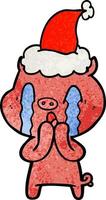 crying pig textured cartoon of a wearing santa hat vector