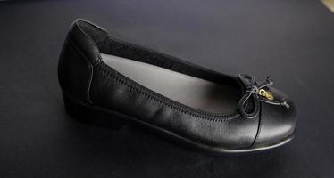 Close up woman black leather shoes. photo