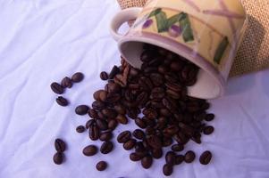 coffee bean background spilled in glass. isolated white background photo