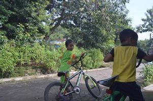 Gresik, indonesia, maret 2022 - the state of the village in the morning with a portrait of a small child playing photo