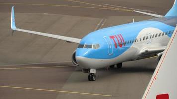 AMSTERDAM, THE NETHERLANDS   JULY 29, 2017 - TUI Fly Boeing 737 PH TFB taxiing after landing and KLM Cityhopper Embraer ERJ 175 PH EXK towing. Shiphol Airport, Amsterdam, Holland video