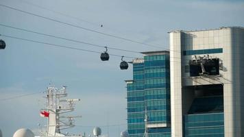 SINGAPORE   NOVEMBER 24, 2018 - Cable car from above going to the park Sentosa and Ocean Ship in Singapore Cruise Centre Regional Ferry Terminal   HarbourFront and the video