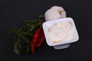 Mayonnaise sauce in the white bowl served thyme and garlic photo