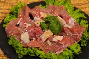 Beef carpaccio with parmesan cheese photo