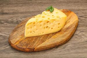 Maasdam cheese - yellow triangle with holes photo