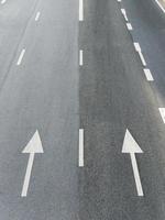 The white painted arrow on the highway for direction to the town. photo