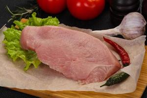 Raw Turkey steak served rosemary photo