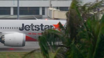 PHUKET, THAILAND   DECEMBER 3, 2016 - JetStar Boeing 787 Dreamliner VH VKA taxiing after landing at Phuket airport. Rainy weather video