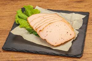 Boiled pork sausage over board photo