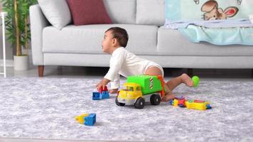 Crawling baby. The baby is crawling around the house and playing with his toys. video
