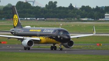 DUSSELDORF, GERMANY   JULY 22, 2017 - Eurowings Airbus 320 D AIZR Borussia Dortmund livery taxiing to runway before departure. Dusseldorf airport video