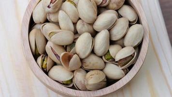 Top view slow motion shot of moving Pistachio nuts, healthy food concept video
