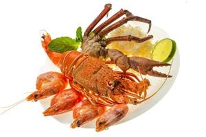 Spiny lobster, shrimps, crab legs  and rice photo