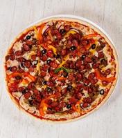 Pizza with sausages and minced meat