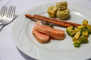 Salmon with avocado and artichoke photo