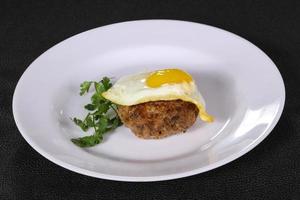 Beef cutlet with egg and coriander photo