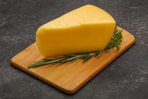 Hard cheese piece served rosemary photo