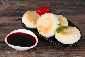 Curd pancakes with jam and stravberry photo