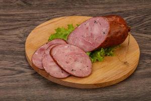 Smoked ham sausage with spices photo