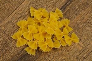 Raw dry farfalle pasta for cooking photo