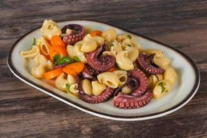 Pasta with octopus and yellow tomatoes photo