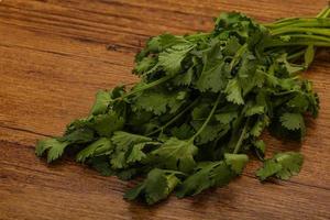 Green coriander or cilanto leaves heap photo